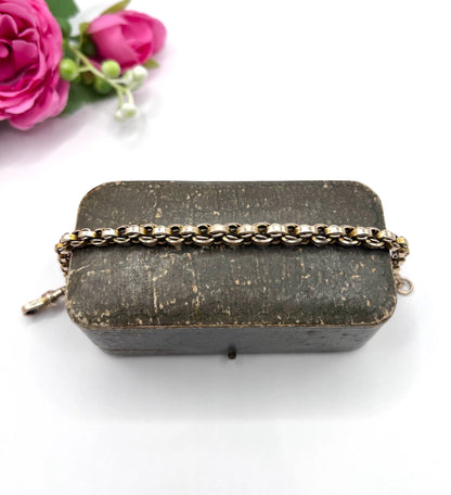 A gold round link bracelet with a lobster claw clasp