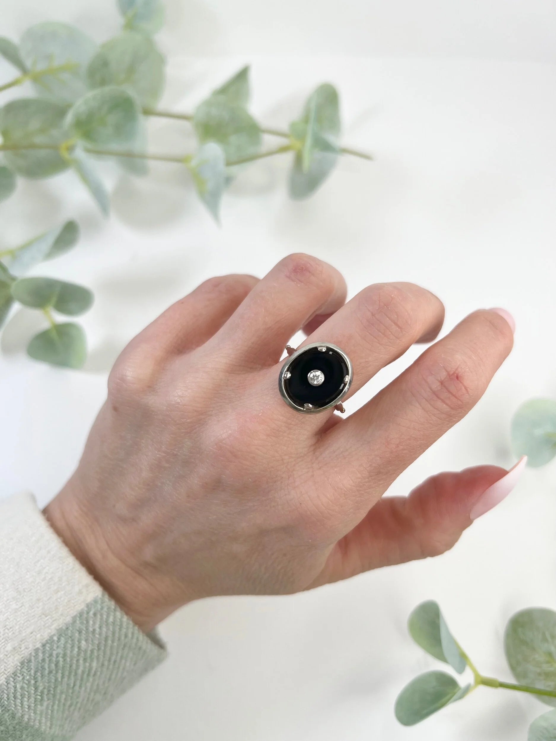 Art Deco 18 Carat Two Colour Gold Oval Onyx and Diamond Halo Ring, Circa 1920