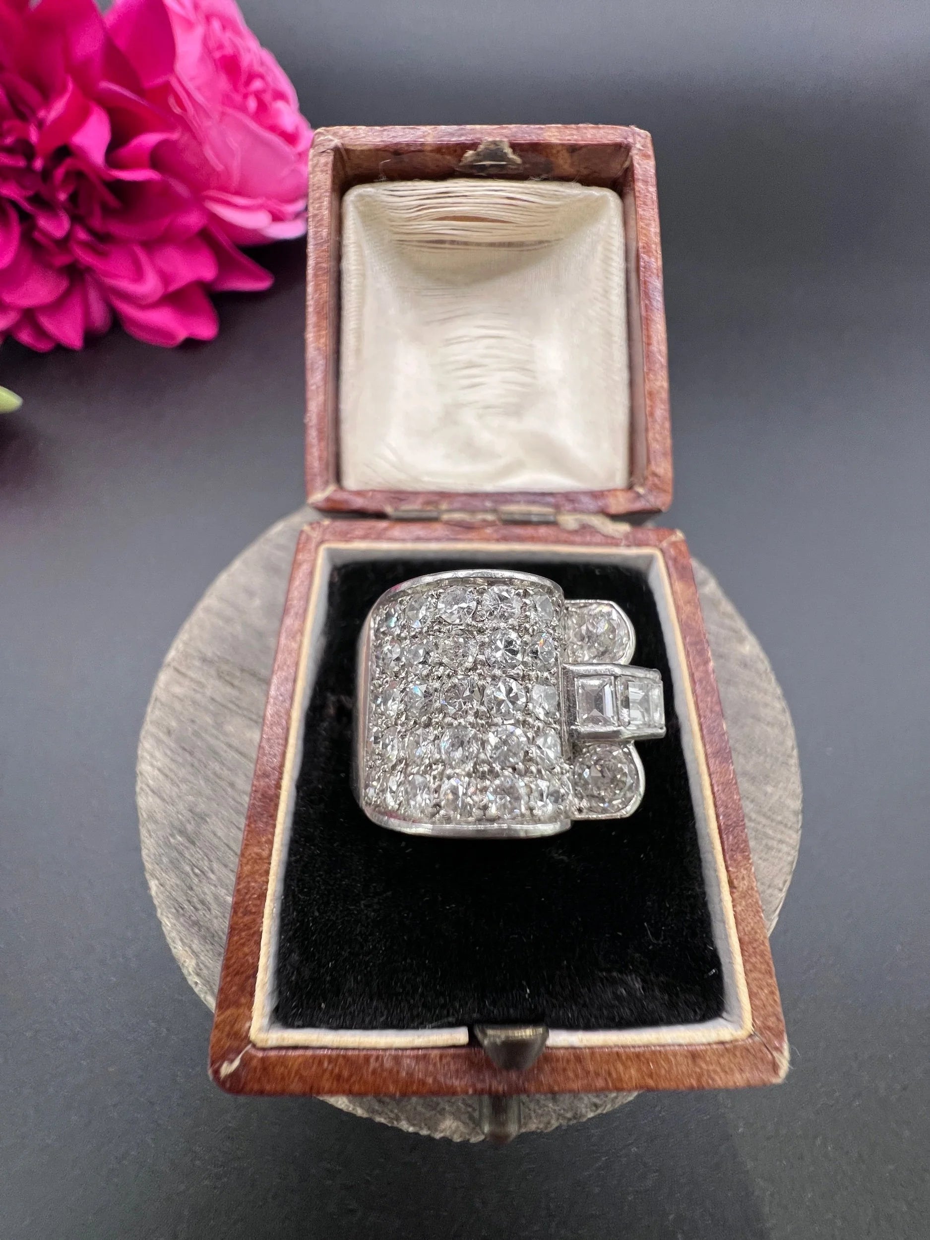 A round diamond tank style cocktail ring in platinum, in a ring box