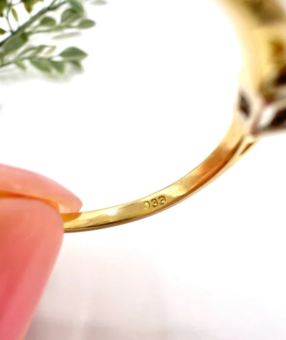 Close-up of 033 stamp inside a yellow gold ring shank