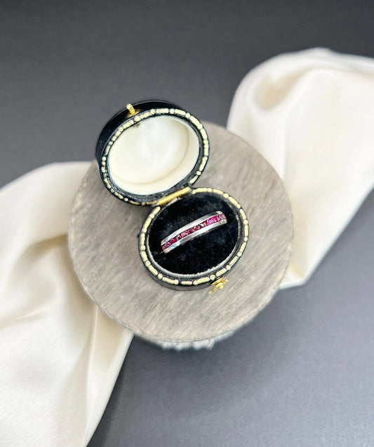 A ruby full eternity band in platinum, in a ring box