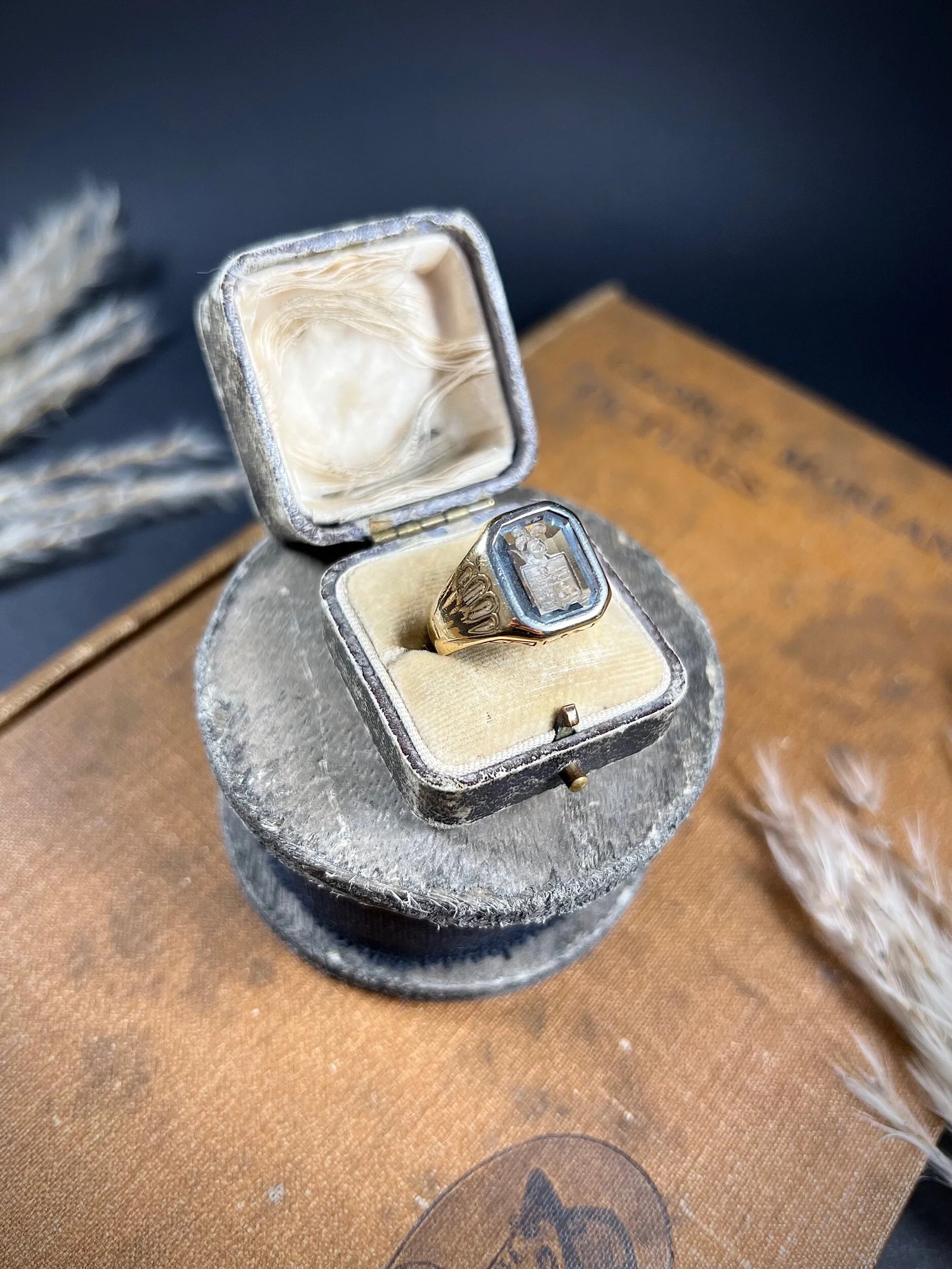 A yellow gold blue glass intaglio signet ring, in a ring box