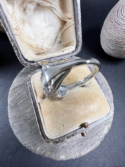 A three row diamond band ring in platinum in an antique ring box