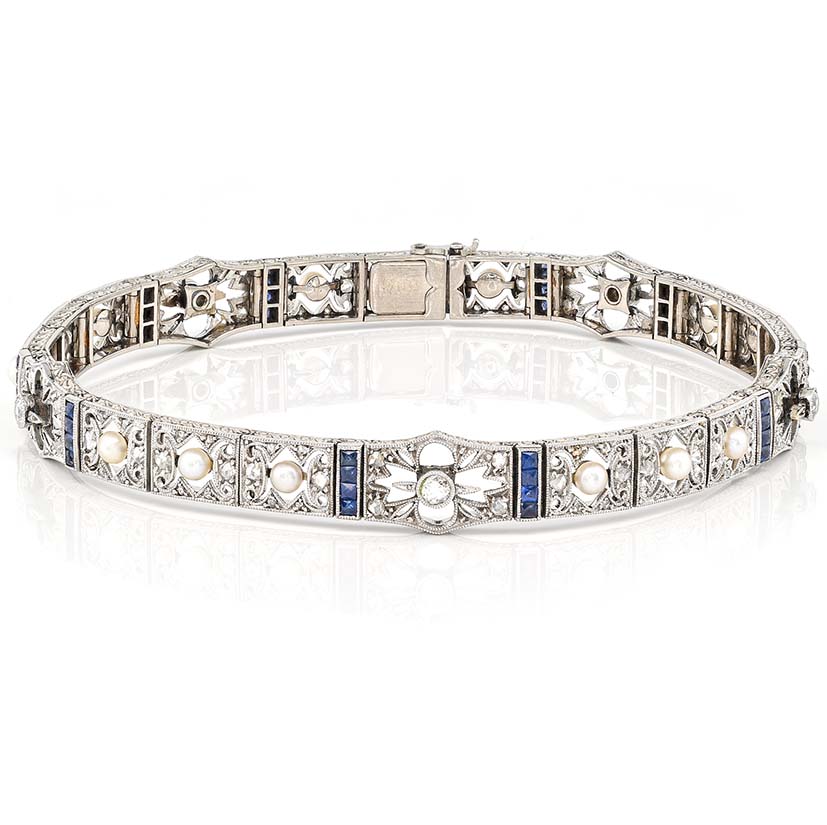 Edwardian Antique Natural Pearl Diamond and Sapphire Filigree Bracelet, fine 18ct white gold openwork panels adorned with old European cut and rose-cut diamonds, natural pearls and blue sapphires. Circa 1900