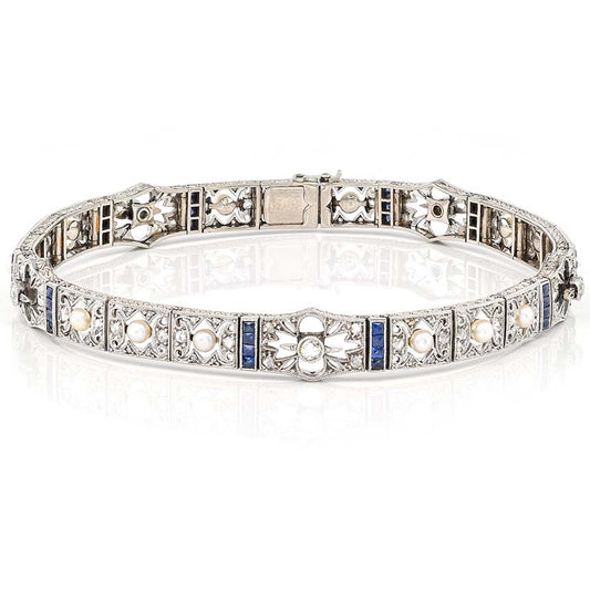 Edwardian Antique Natural Pearl Diamond and Sapphire Filigree Bracelet, fine 18ct white gold openwork panels adorned with old European cut and rose-cut diamonds, natural pearls and blue sapphires. Circa 1900