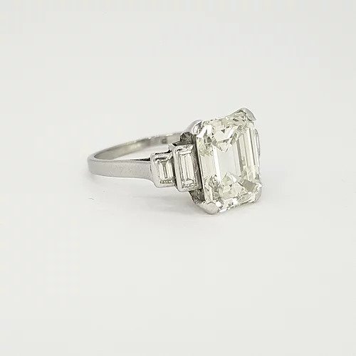 Art Deco Asscher Cut Diamond and Platinum Ring; central 4ct asscher cut diamond flanked by graduated baguette cut diamond set shoulders