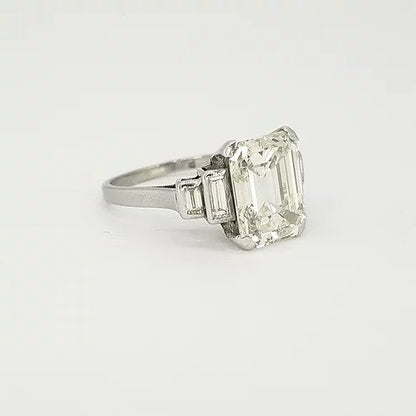 Art Deco Asscher Cut Diamond and Platinum Ring; central 4ct asscher cut diamond flanked by graduated baguette cut diamond set shoulders
