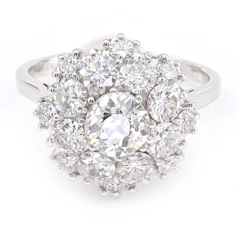 Vintage 2.95ct Diamond Cluster Engagement Ring, 0.95ct old European-cut diamond surrounded by 2cts round brilliant-cut diamonds in floral and petal design in 18ct white gold. Circa 1950s