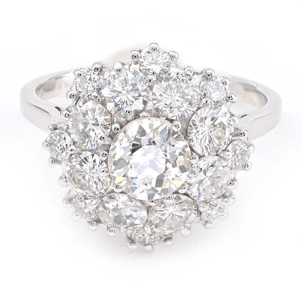Vintage 2.95ct Diamond Cluster Engagement Ring, 0.95ct old European-cut diamond surrounded by 2cts round brilliant-cut diamonds in floral and petal design in 18ct white gold. Circa 1950s