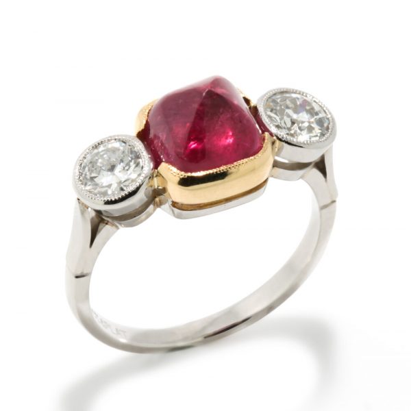 Art Deco Natural Cabochon Ruby and Diamond Trilogy Ring; central 4.52ct cabochon-cut natural ruby flanked by 1cts old-cut diamonds, in 18ct yellow gold and platinum, Circa 1920, with GCS certificate