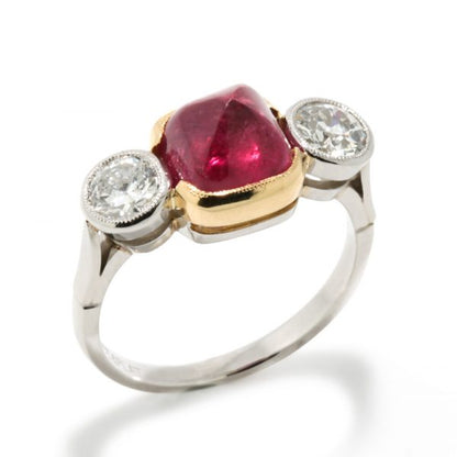 Art Deco Natural Cabochon Ruby and Diamond Trilogy Ring; central 4.52ct cabochon-cut natural ruby flanked by 1cts old-cut diamonds, in 18ct yellow gold and platinum, Circa 1920, with GCS certificate
