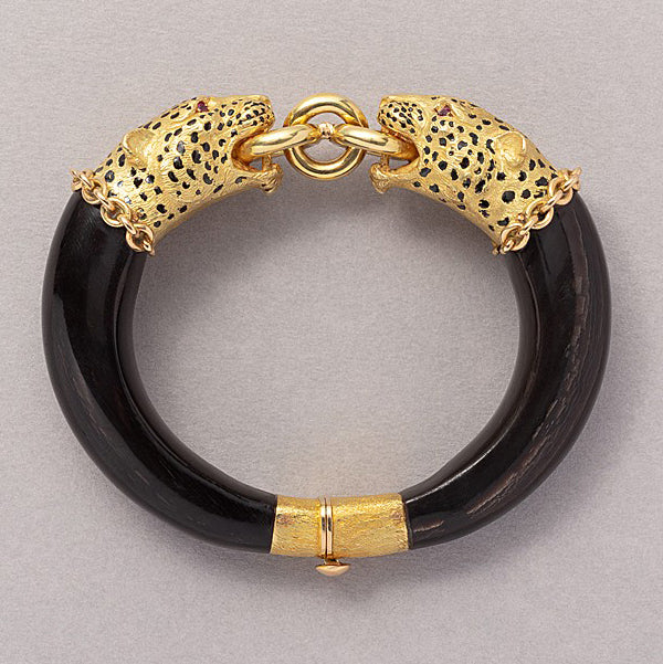 Vintage Gold Panther Head and Wood Bangle Bracelet, single mobile gold ring held in the mouths jaws of two 18ct yellow gold panther heads with ruby eyes and black enamel spots with hidden clasp and safety clasp at the back of the bangle