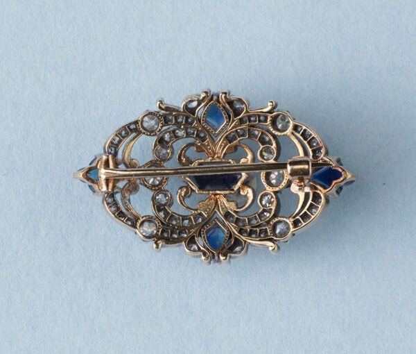 Antique Victorian 3.77ct Sapphire and Diamond Brooch; mixed cut sapphires accented with 1.52cts old-cut diamond set swirls. 19th century.