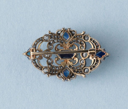 Antique Victorian 3.77ct Sapphire and Diamond Brooch; mixed cut sapphires accented with 1.52cts old-cut diamond set swirls. 19th century.