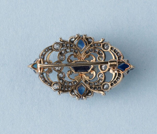Antique Victorian 3.77ct Sapphire and Diamond Brooch; mixed cut sapphires accented with 1.52cts old-cut diamond set swirls. 19th century.