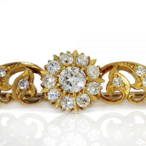 Vintage Diamond Floral Cluster Bar Brooch; featuring three floral clusters and diamond set leaf swirls, 2.55 carat total, Circa 1970s