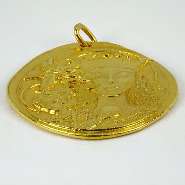 Virgin of the Lilies 18ct Yellow Gold Pendant; designed as a medal depicting the Madonna and Child with lilies, with cross on reverse
