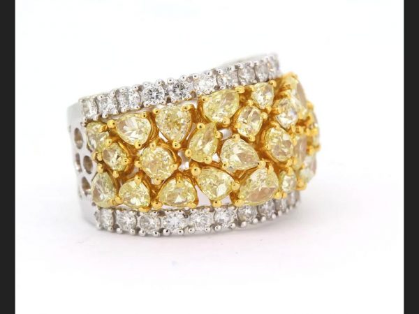 Yellow and White Diamond Ring; Central band of pear, round and oval cut fancy yellow diamonds, highlighted by round cut white diamonds, est. total 3.50 ct