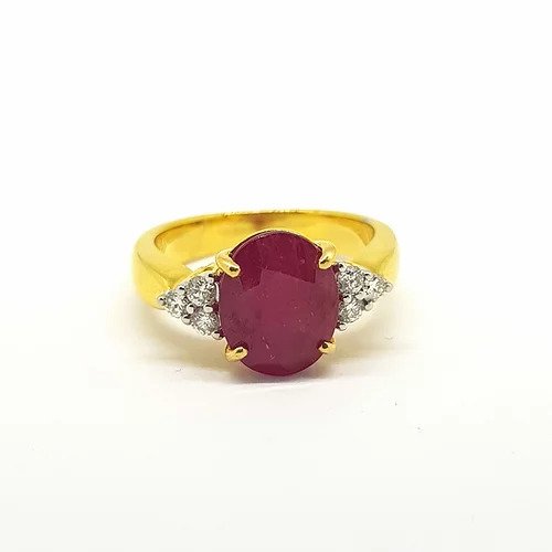 Ruby and Diamond Engagement Dress Ring; central 3.50 carat oval faceted ruby is flanked on either side by three diamonds in a trefoil design, in 18ct yellow gold