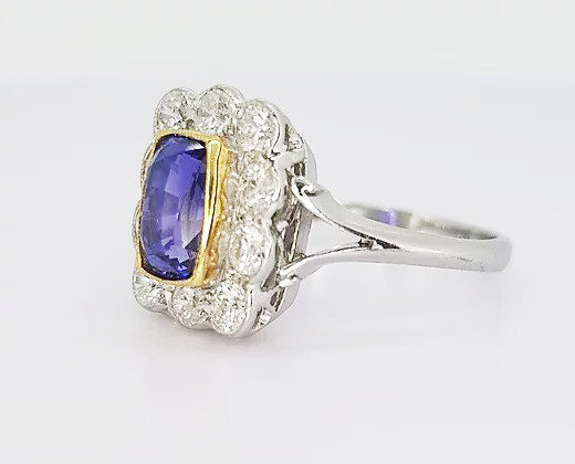 2.16ct Natural Sapphire and Diamond Cluster Ring; 2.16 carat cushion-shaped natural sapphire, surrounded by 0.98cts diamonds, in 18ct white and yellow gold