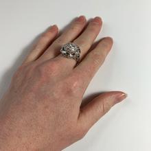 Vintage Diamond and Platinum Domed Cocktail Ring; central dome encrusted with brilliant diamonds, with a curve of tapered baguette diamonds and diamond set shoulders, 3.72 carat total. Numbered 995644