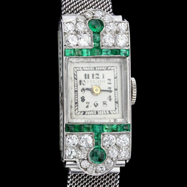 Art Deco Diamond, Emerald and Platinum Manual Cocktail Watch by Drecier and Co; set with 0.64cts emeralds and 0.90cts old-cut diamonds, Circa 1920s