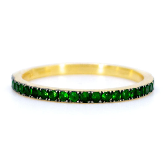 A green garnet half eternity band ring in yellow gold