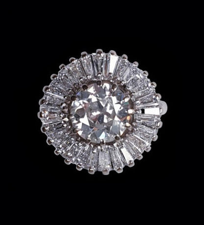 Old Cut Diamond Ballerina Cluster Ring; central 1.80 carat old European-cut diamond surrounded by 1.50 carats of tapering baguette-cut diamonds