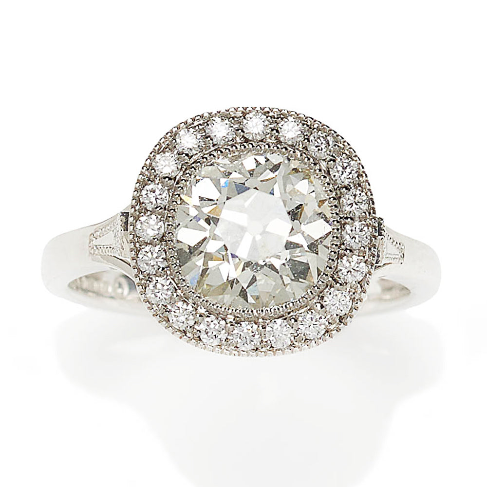Diamond cluster ring in platinum principal diamond surrounded 20 diamonds plus a diamond in each shoulder.