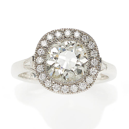 Diamond cluster ring in platinum principal diamond surrounded 20 diamonds plus a diamond in each shoulder.