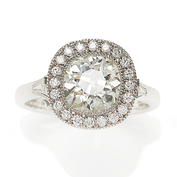 Diamond cluster ring in platinum principal diamond surrounded 20 diamonds plus a diamond in each shoulder.