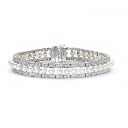 Modern Pearl and Diamond Bracelet in Platinum, row of forty-one cultured pearls flanked either side by 3.81cts round brilliant-cut diamonds in paired grain settings