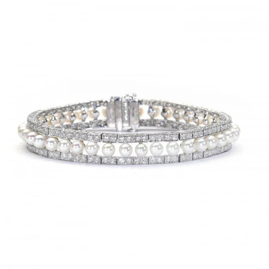 Modern Pearl and Diamond Bracelet in Platinum, row of forty-one cultured pearls flanked either side by 3.81cts round brilliant-cut diamonds in paired grain settings