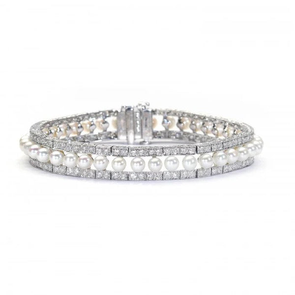 Modern Pearl and Diamond Bracelet in Platinum, row of forty-one cultured pearls flanked either side by 3.81cts round brilliant-cut diamonds in paired grain settings