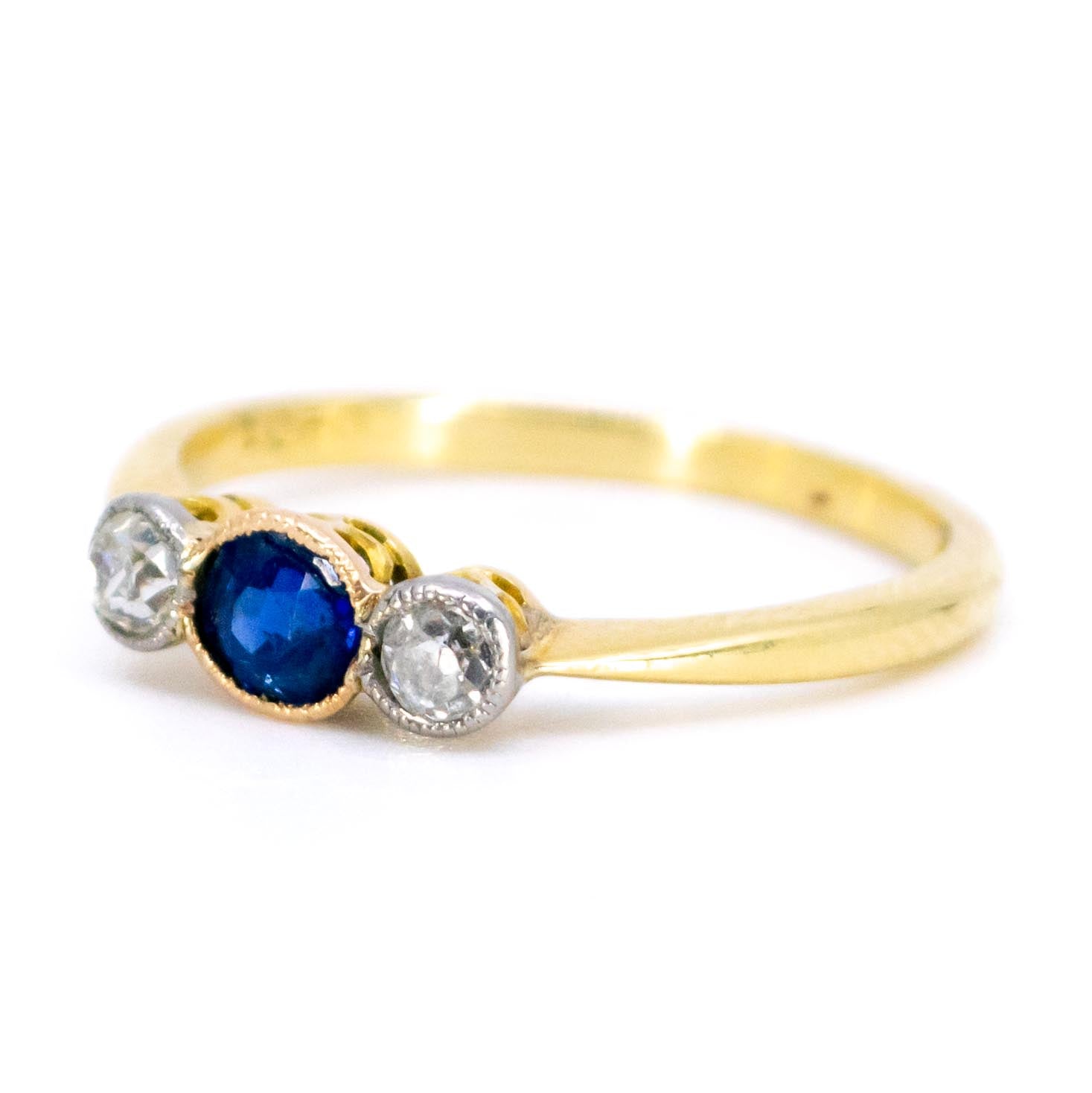 A three stone sapphire and diamond ring in yellow and white gold