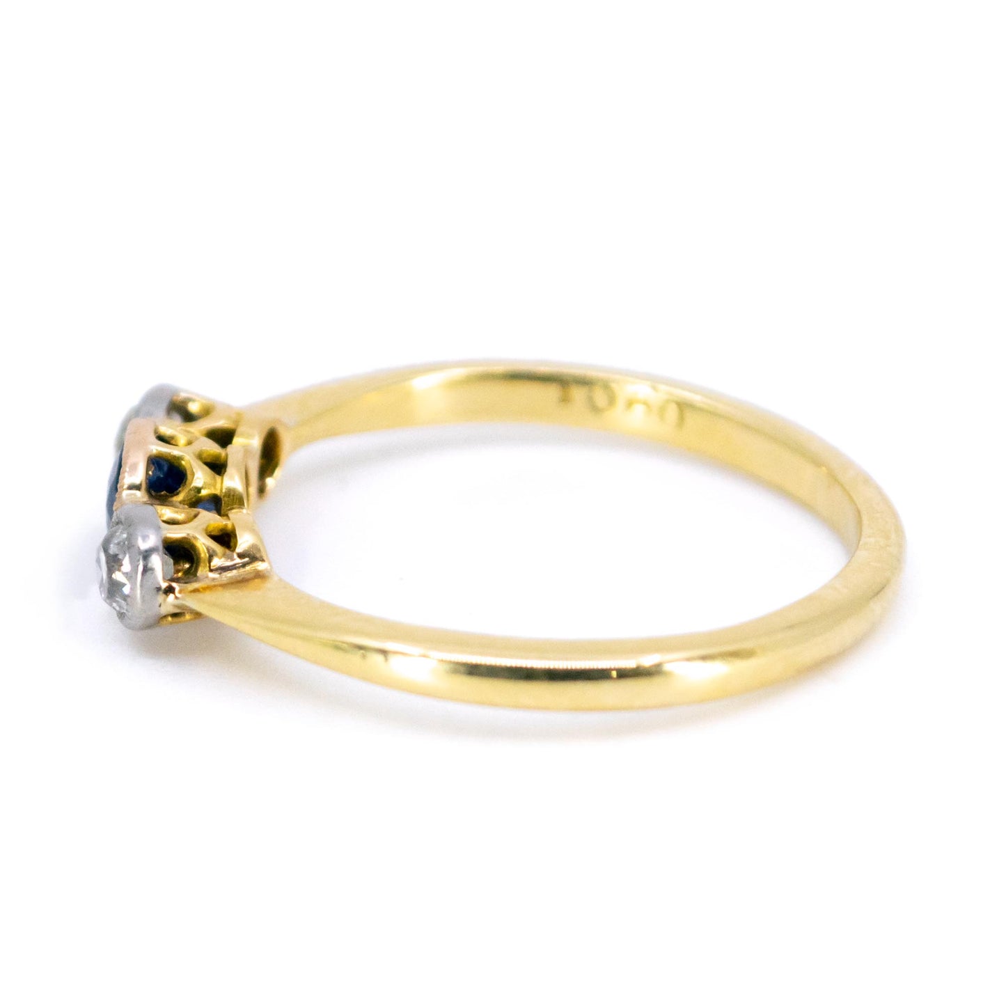 A three stone sapphire and diamond ring in yellow and white gold