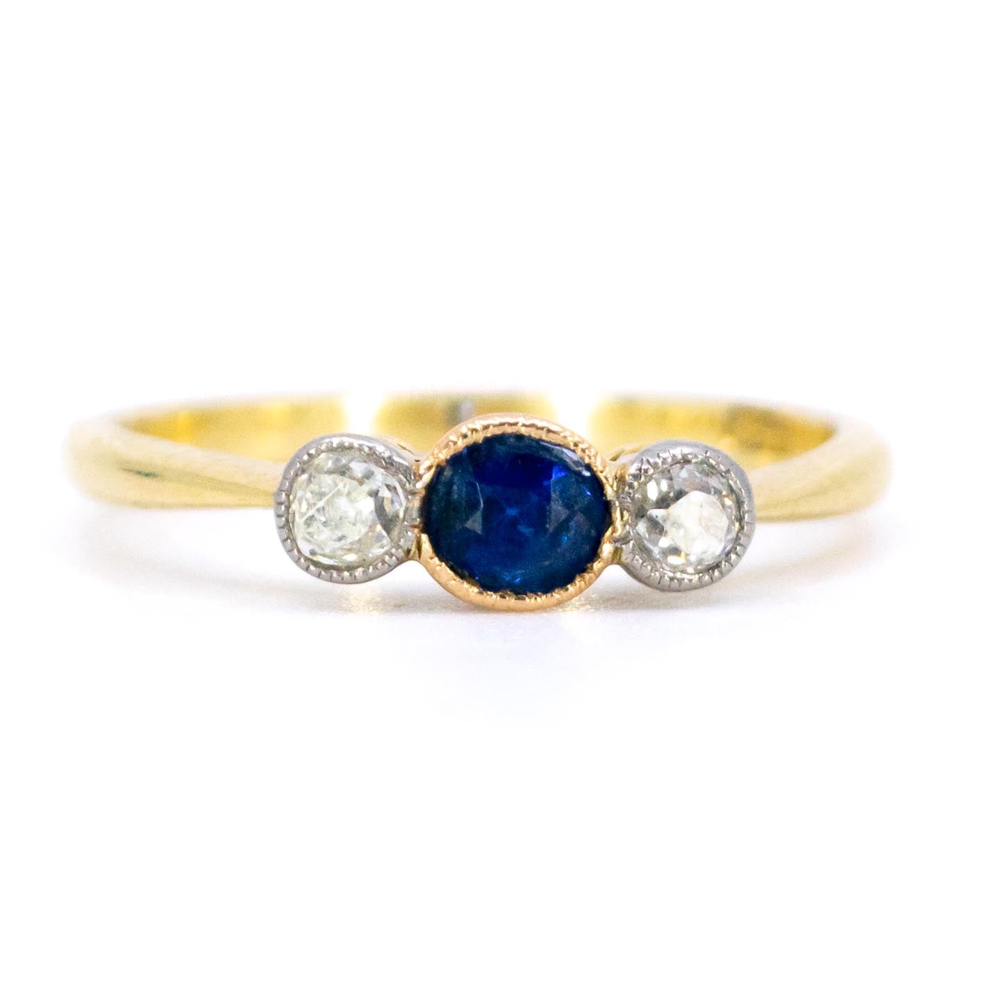 A three stone sapphire and diamond ring in yellow and white gold