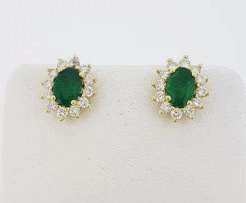 1.37ct Emerald and Diamond Oval Cluster Stud Earrings; oval faceted emeralds surrounded by 0.70cts brilliant-cut diamonds, 18ct yellow gold.