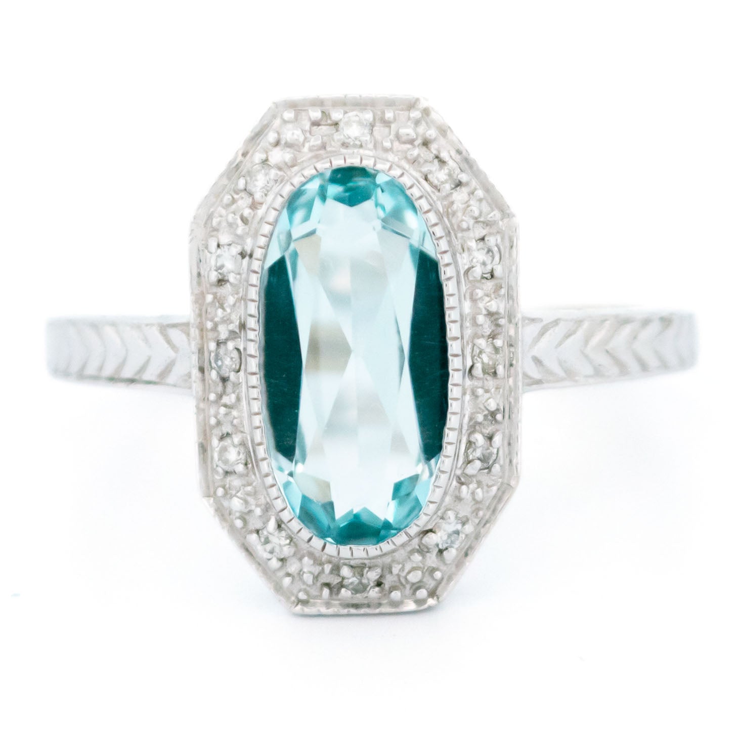 An oval blue topaz and diamond dress ring in white gold