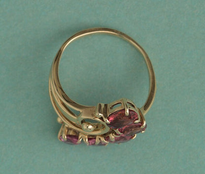 Vintage Pink Tourmaline and 18ct Yellow Gold Flower Ring; set with five oval faceted pink tourmalines beautifully graduating in size and colour, Circa 1950