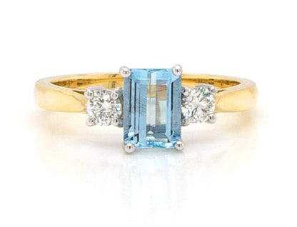 Emerald Cut Aquamarine and Diamond Three Stone Ring; 0.91ct emerald-cut aquamarine flanked by brilliant-cut diamonds totalling 0.25cts, 18ct yellow gold.