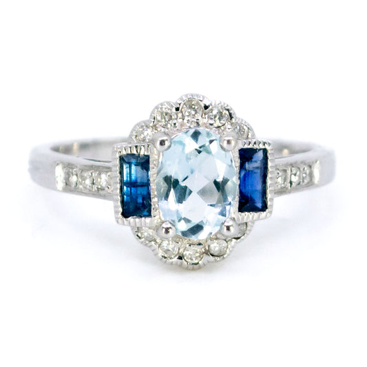 A white gold cluster ring with aquamarine, sapphires and diamonds