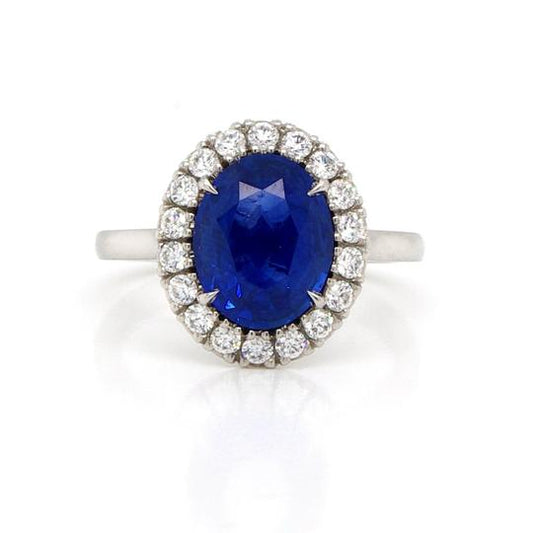 Sapphire, Diamond and Platinum Oval Cluster Ring; 2.77ct oval faceted sapphire cluster ring surrounded by 0.40cts brilliant cut diamonds