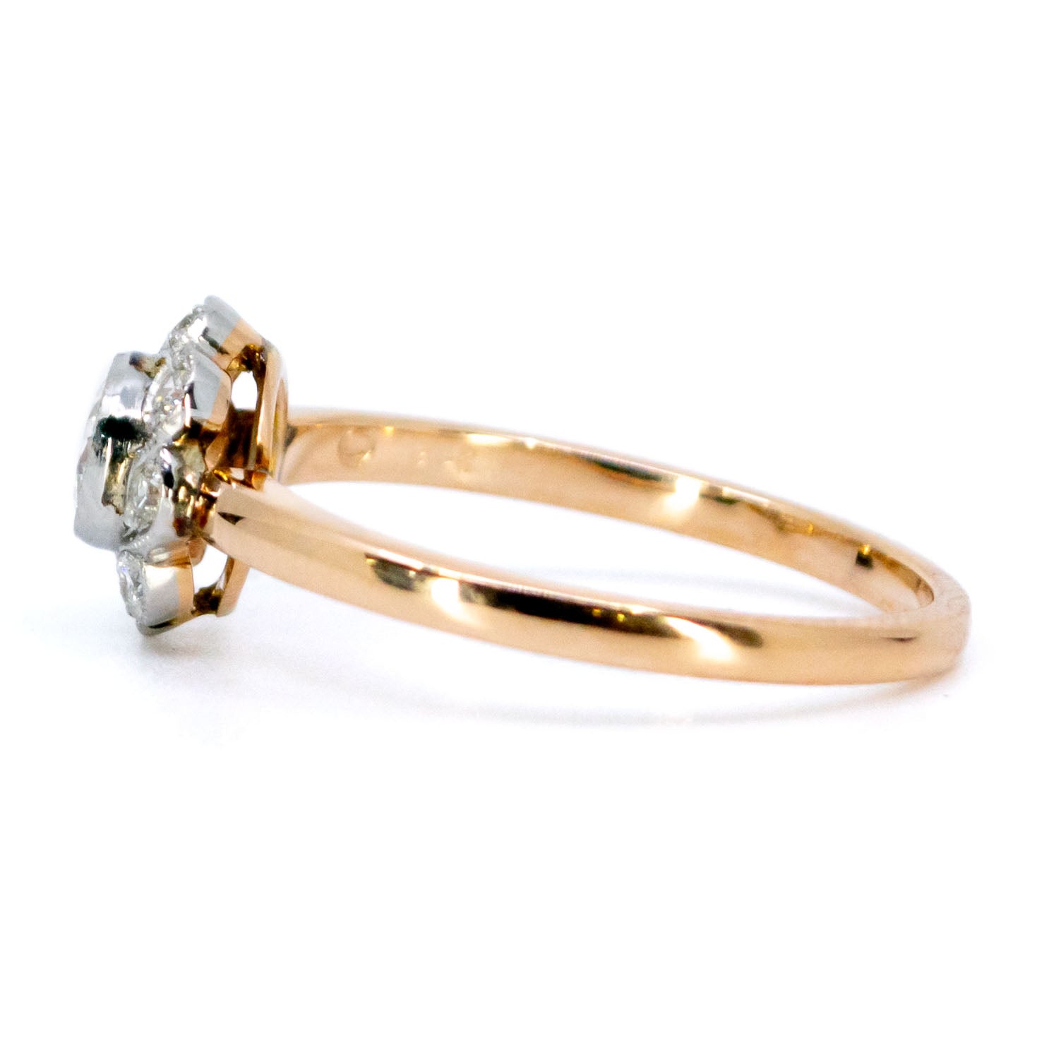 A round diamond cluster ring in gold and platinum