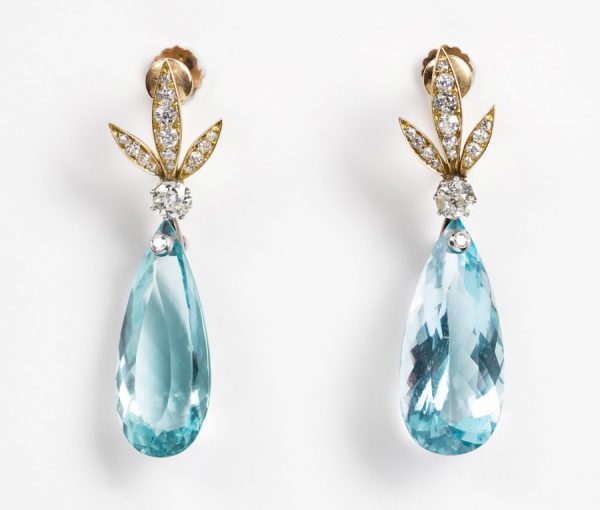 Vintage Aquamarine and Diamond Drop Earrings; diamond set stylized gold leaves suspend a large faceted pear-shaped aquamarine drop