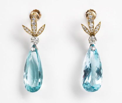 Vintage Aquamarine and Diamond Drop Earrings; diamond set stylized gold leaves suspend a large faceted pear-shaped aquamarine drop