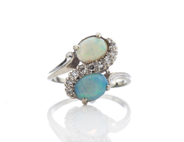 Vintage 1.50ct Opal and Diamond Crossover Ring; set with two opals enveloped by 0.18cts diamonds, 14ct white gold, Circa 1960s
