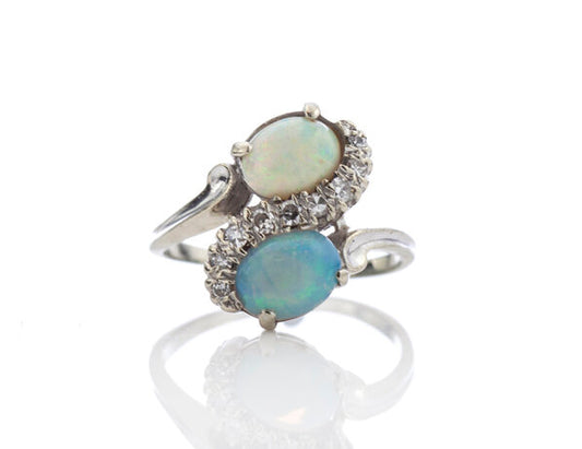 Vintage 1.50ct Opal and Diamond Crossover Ring; set with two opals enveloped by 0.18cts diamonds, 14ct white gold, Circa 1960s