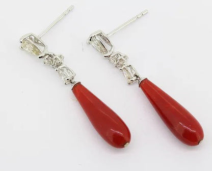 Coral and Diamond Drop Earrings; each featuring a coral drop suspended by three graduated diamonds, claw set in 18ct white gold