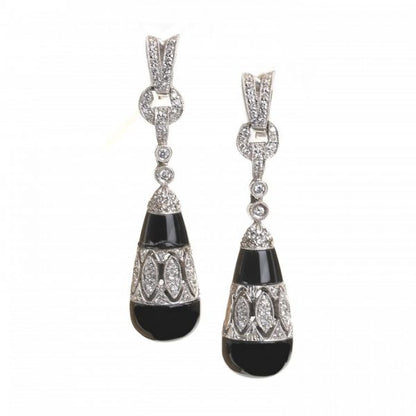 Black Onyx and Diamond Drop Earrings; torpedo-shaped black onyx drops, with diamond-set cut-out mid-section and suspended by diamond links, in 18ct white gold
